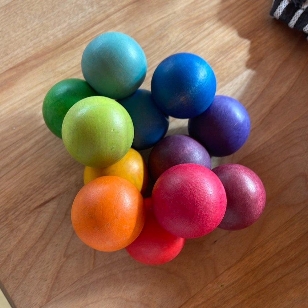 Wooden ball toy for baby. Rainbow